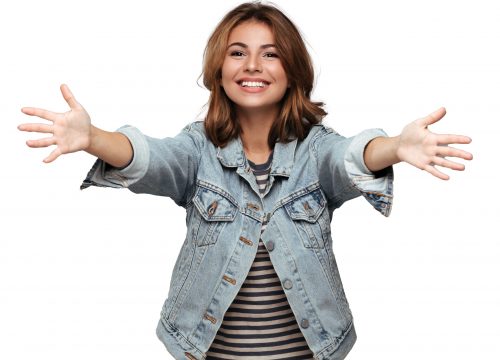 Close-up portrait of friendly pretty woman stretching her arms, wants to hug you, looking at camera, isolated on gray background